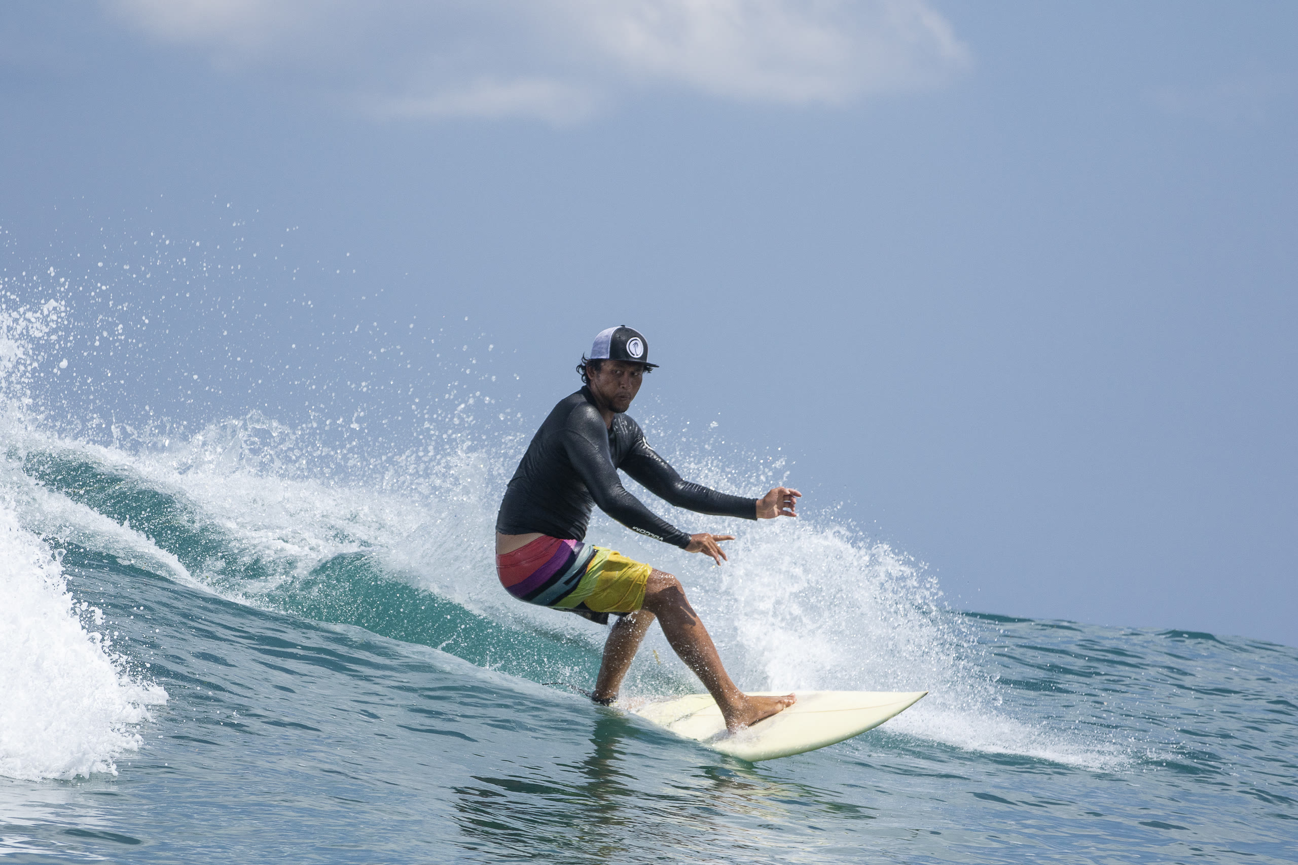Surfer executing a powerful bottom turn with spray