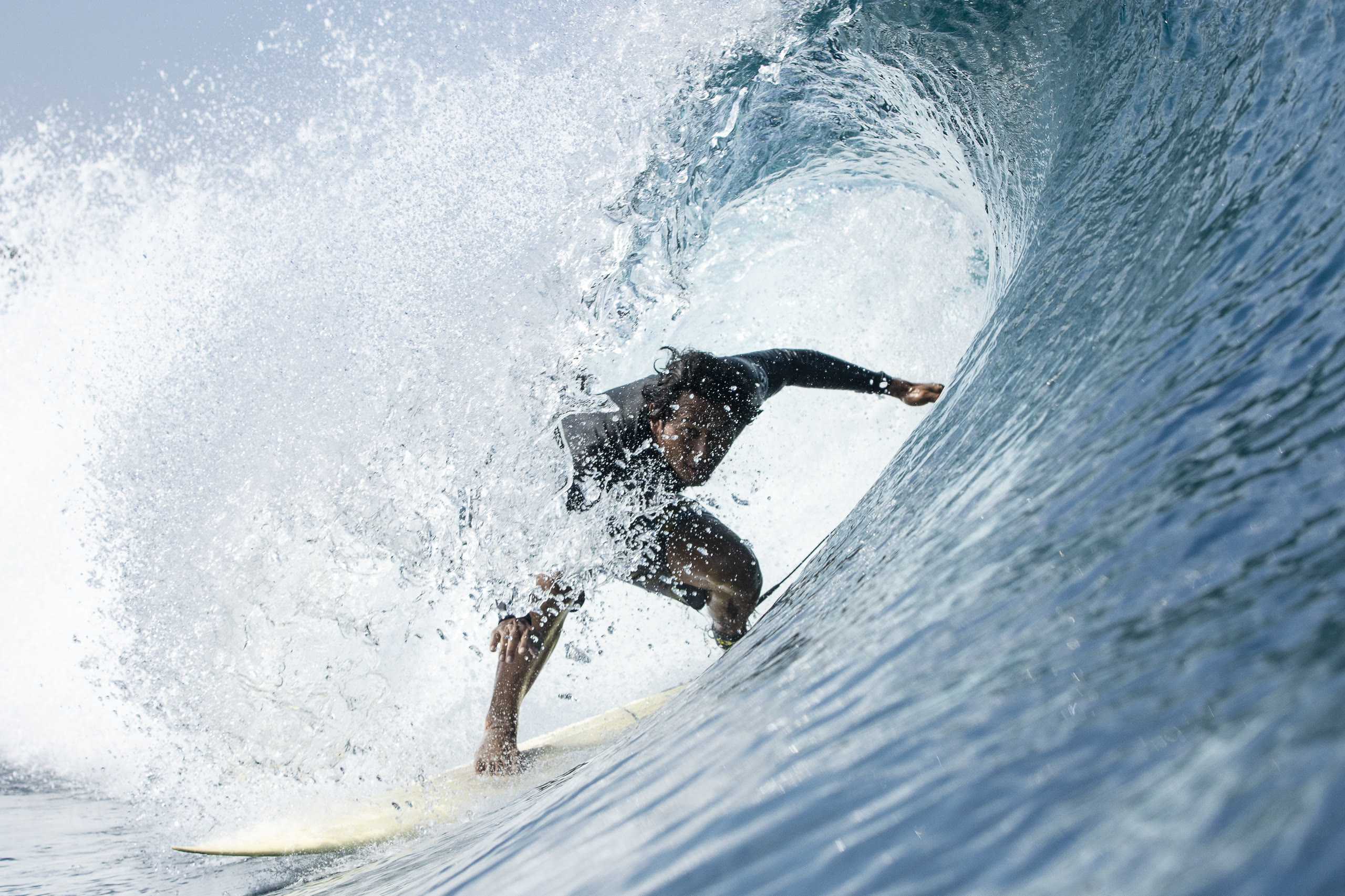 Surfer inside a barrel tube ride at Kuta Reef